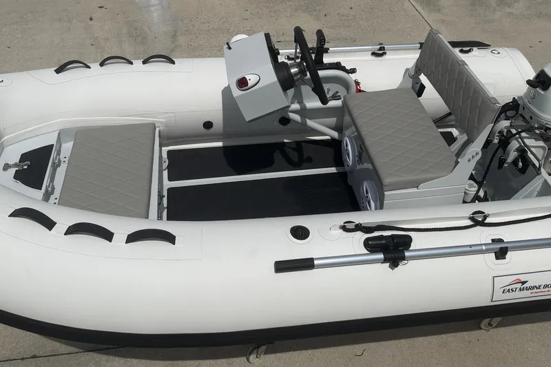 Slide: The Image of Inflatable East Marine 320 boat, 2026 model, featuring seating and steering console. - 14