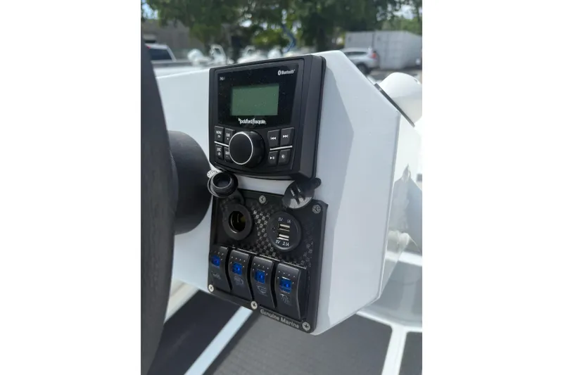 Slide: The Image of Control panel of 2026 East Marine 320 boat with audio system and switches. - 8