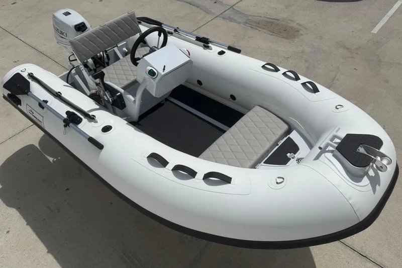 Slide: The Image of 2026 East Marine 320 inflatable boat with Suzuki motor, featuring sleek design and comfortable seating. - 9
