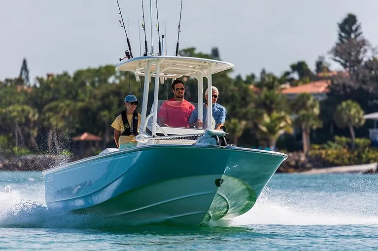 Slide: The Image of Manufacturer Provided Image: 2026 Boston Whaler 210 Montauk boat cruising on water with three passengers. - 1