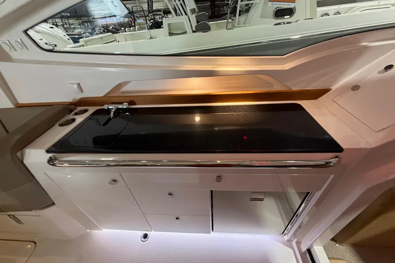 Slide: The Image of Interior of 2025 Nimbus Weekender 9, featuring a sleek kitchenette with a black countertop. - 12