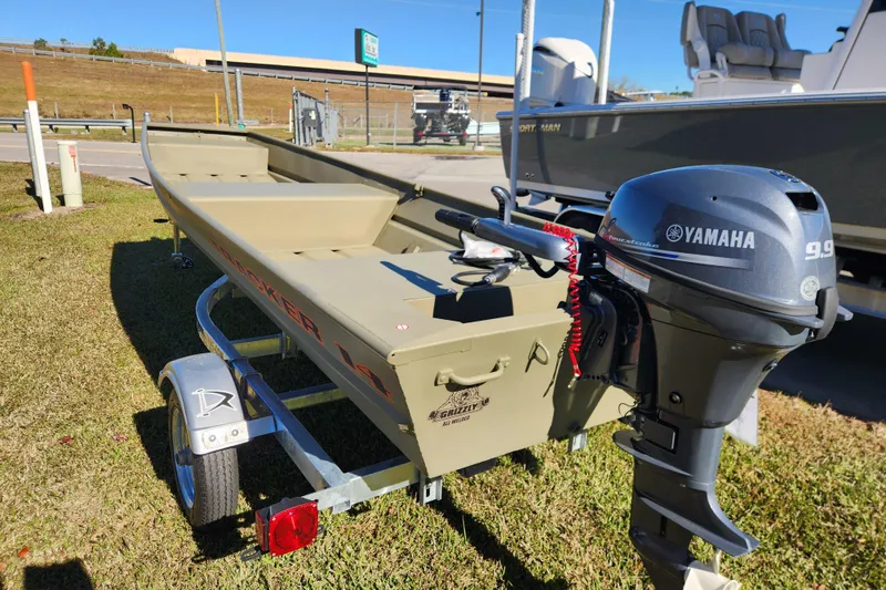 Slide: The Image of 2026 Tracker Grizzly 1436 Utility boat with Yamaha 9.9 motor on trailer. - 2