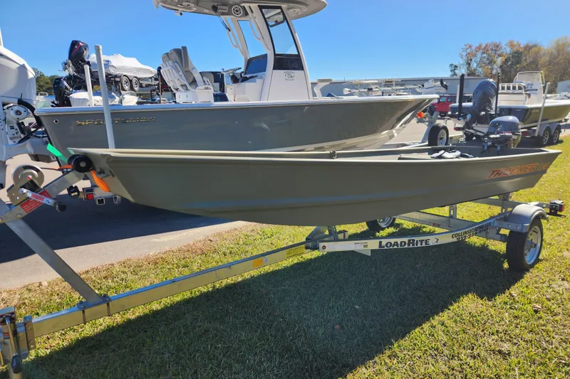 Slide: The Image of 2026 Tracker Grizzly 1436 Utility boat on LoadRite trailer, displayed outdoors. - 5