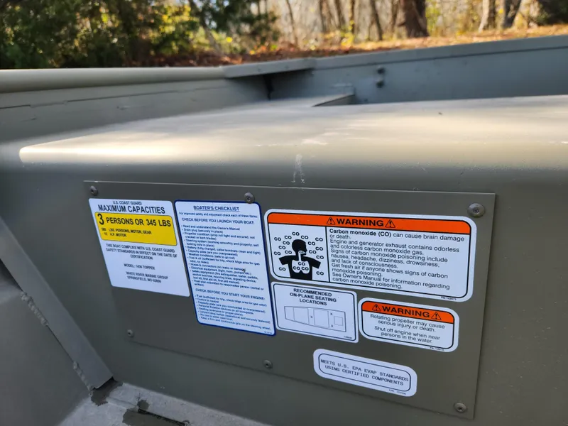Slide: The Image of 2025 Tracker Grizzly 1436 Utility boat safety and capacity warning labels. - 6