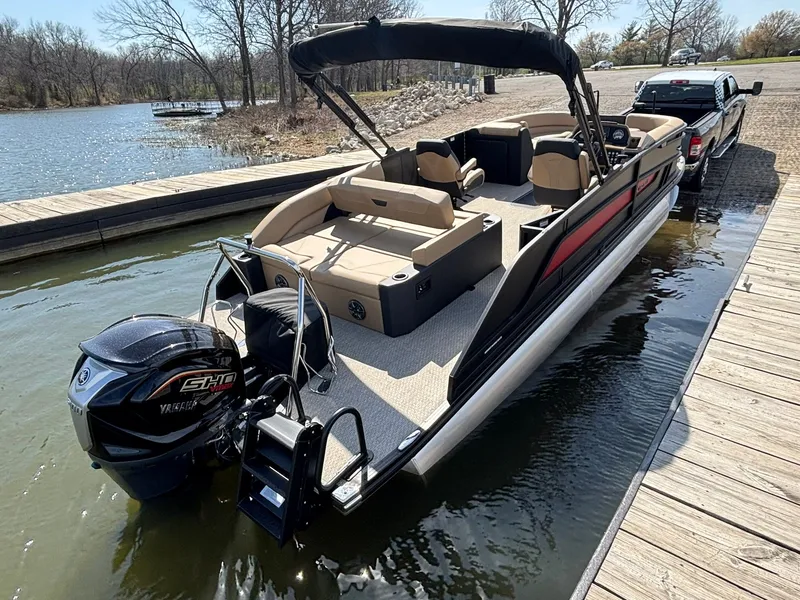 Slide: The Image of Evotti 523 QL 2026 pontoon boat docked at lakeside. - 6