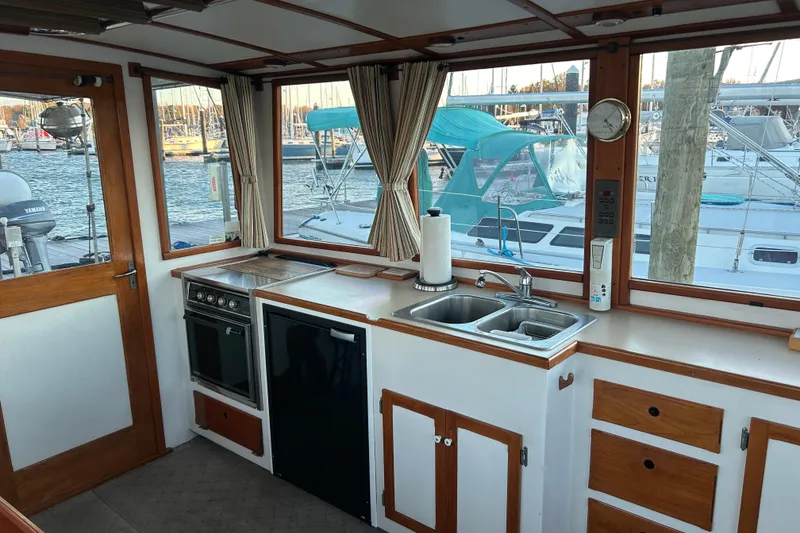 Slide: The Image of Interior of a 1991 Holland 38 boat with kitchen and marina view. - 11