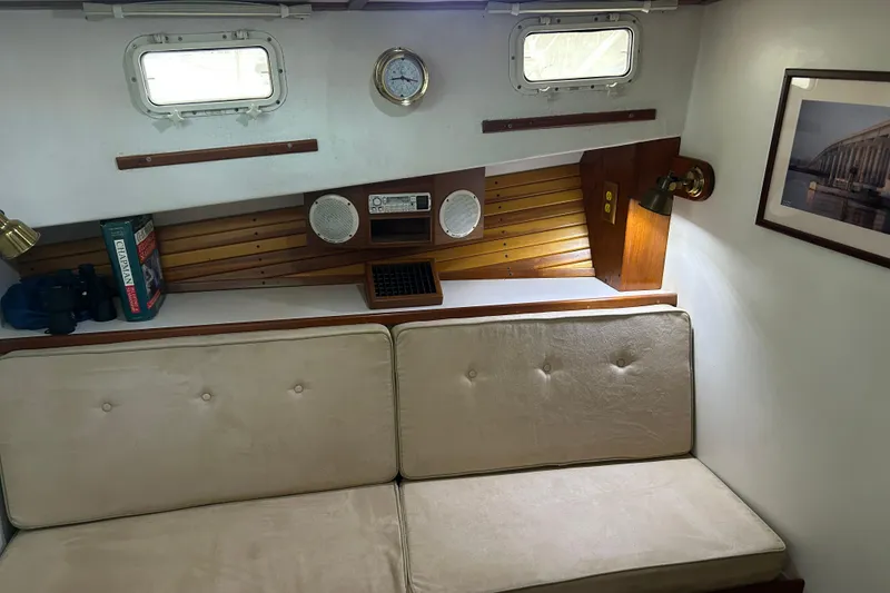 Slide: The Image of Interior of a 1991 Holland 38 boat with beige seating and nautical decor. - 21