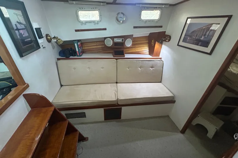 Slide: The Image of Cozy interior of 1991 Holland 38 boat with cushioned seating and nautical decor. - 22