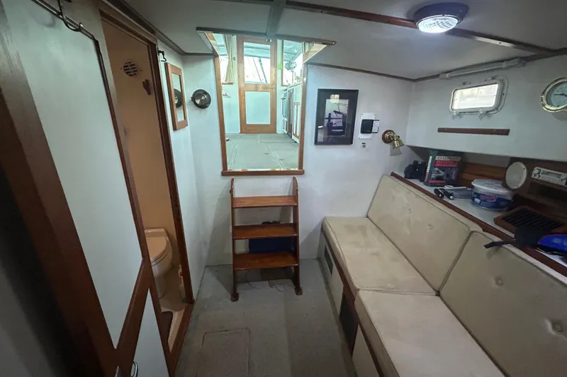 Slide: The Image of Interior of 1991 Holland 38 boat with seating, storage, and nautical decor. - 24