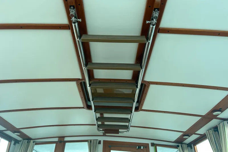 Slide: The Image of Ceiling view of 1991 Holland 38 boat interior with wooden beams and metal ladder. - 25