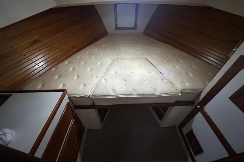 Slide: The Image of Cozy cabin interior of a 1991 Holland 38 boat with wooden paneling and a plush mattress. - 29
