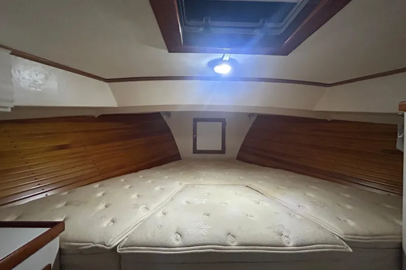 Slide: The Image of Cozy cabin interior of 1991 Holland 38 boat with wooden paneling and overhead light. - 31