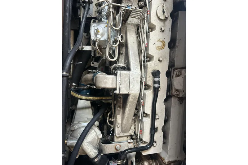Slide: The Image of Close-up of a 1991 Holland 38 engine with visible components and hoses. - 32