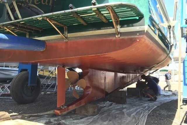 Slide: The Image of Underwater view of a 1991 Holland 38 boat in dry dock, showing propeller and rudder. - 38