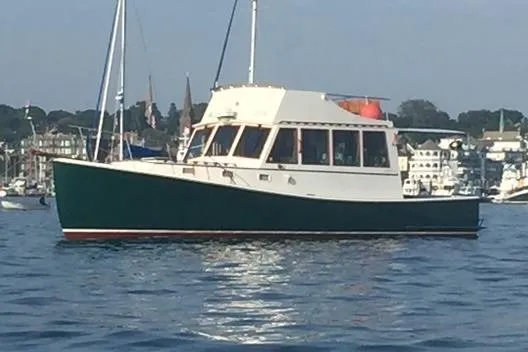 Slide: The Image of 1991 Holland 38 boat on calm water near a marina. - 4