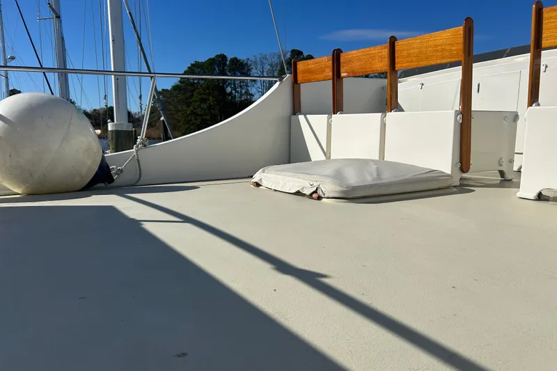Slide: The Image of Deck of 1991 Holland 38 boat with cushion and fender under clear blue sky. - 40