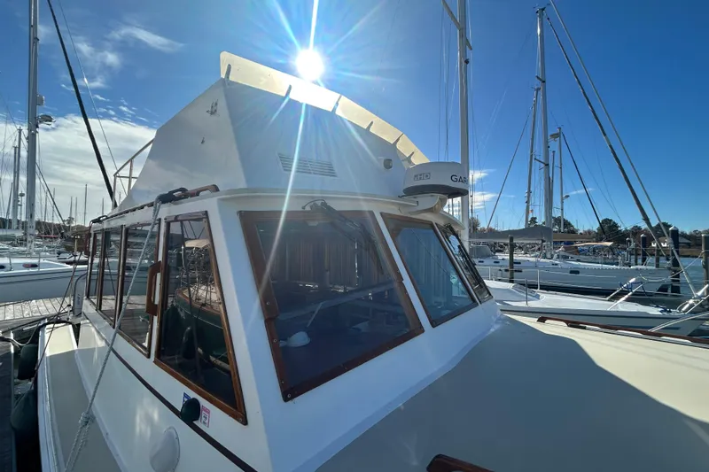 Slide: The Image of 1991 Holland 38 boat docked under a bright sunlit sky. - 42