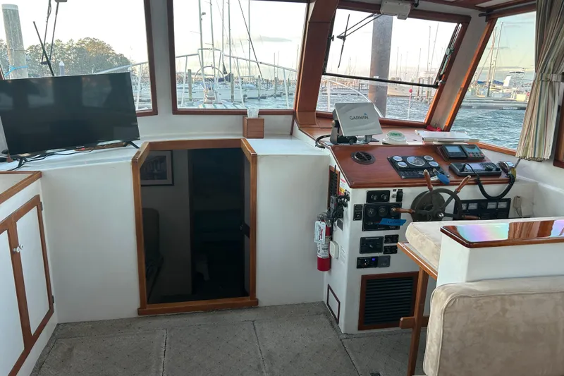 Slide: The Image of Interior of a 1991 Holland 38 boat with helm, controls, and TV. - 6