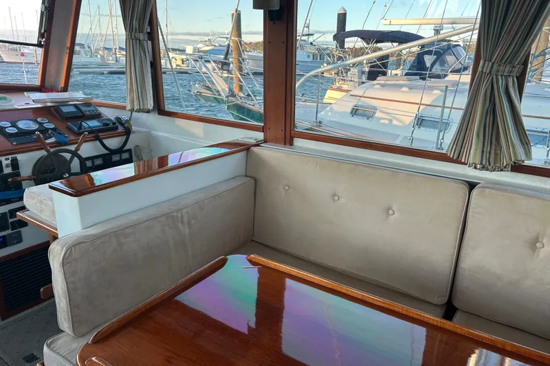 Slide: The Image of Interior of a 1991 Holland 38 boat with plush seating and wooden accents. - 7
