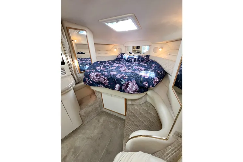 Slide: The Image of Luxurious interior of 2000 Sea Ray 340 Sundancer with floral bedding and elegant design. - 10