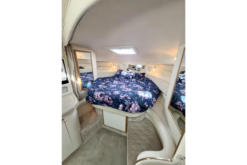 Slide: The Image of Luxurious cabin interior of 2000 Sea Ray 340 Sundancer with floral bedding and mirrors. - 11