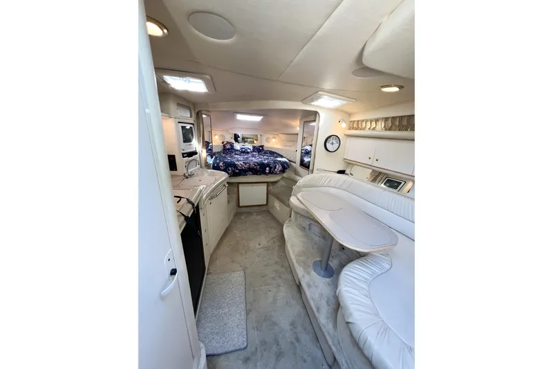 Slide: The Image of Interior of 2000 Sea Ray 340 Sundancer yacht with cozy seating and sleeping area. - 13