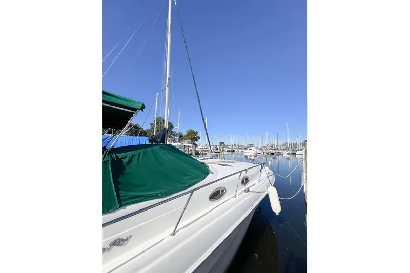 Slide: The Image of 2000 Sea Ray 340 Sundancer docked at marina under clear blue sky. - 2