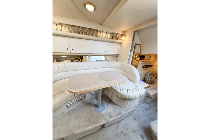 Slide: The Image of Interior of 2000 Sea Ray 340 Sundancer yacht with plush seating and table. - 21