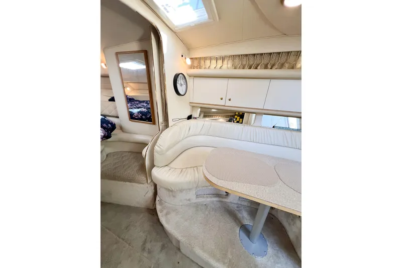 Slide: The Image of Interior of 2000 Sea Ray 340 Sundancer yacht with plush seating and table. - 22