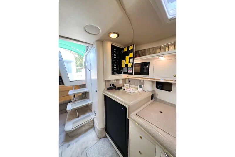 Slide: The Image of Interior of 2000 Sea Ray 340 Sundancer yacht with kitchenette and stairs. - 25
