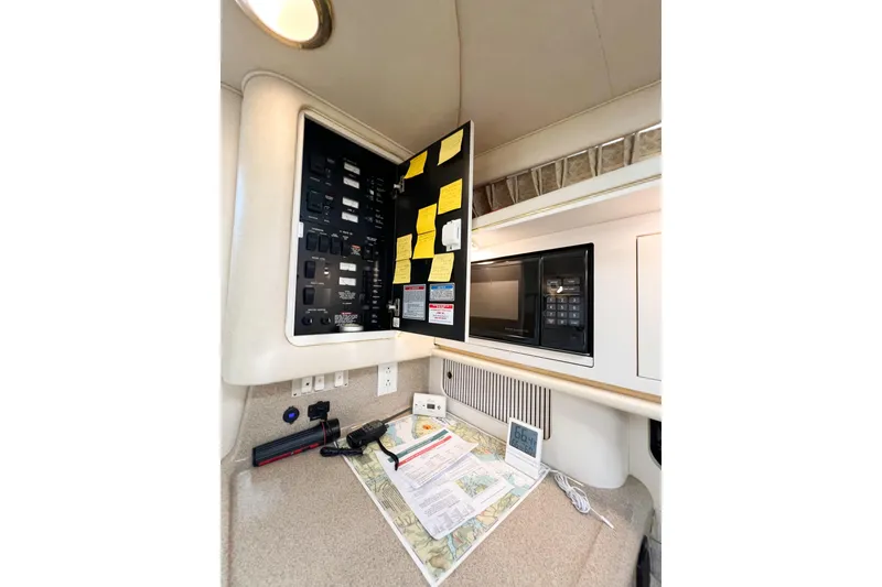 Slide: The Image of Control panel and microwave in 2000 Sea Ray 340 Sundancer yacht interior. - 26