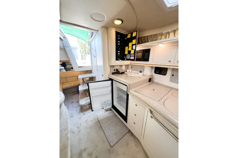 Slide: The Image of Interior of 2000 Sea Ray 340 Sundancer yacht with kitchenette and open fridge. - 27