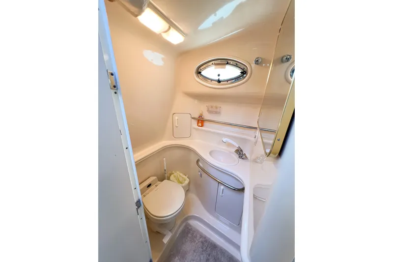 Slide: The Image of Bathroom interior of 2000 Sea Ray 340 Sundancer yacht, featuring sink and toilet. - 28