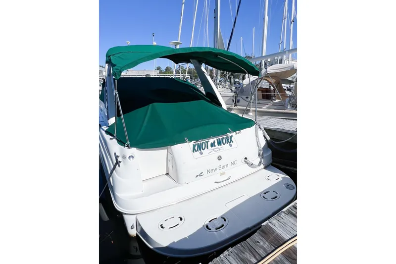 Slide: The Image of 2000 Sea Ray 340 Sundancer docked, green canopy, "Knot at Work" sign, New Bern, NC. - 3