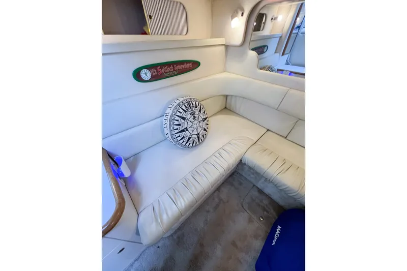Slide: The Image of Interior of 2000 Sea Ray 340 Sundancer with plush seating and nautical decor. - 33