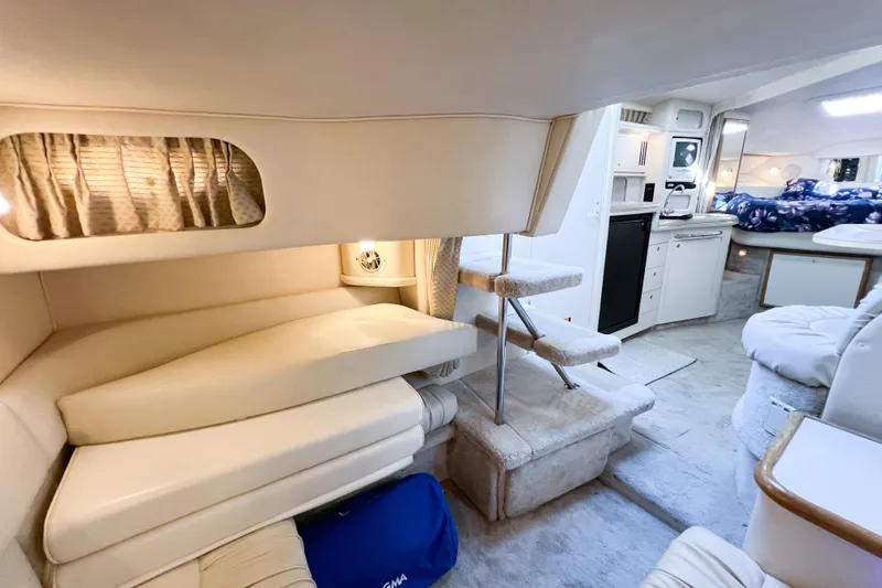 Slide: The Image of Interior of 2000 Sea Ray 340 Sundancer yacht, featuring cozy seating and modern amenities. - 34