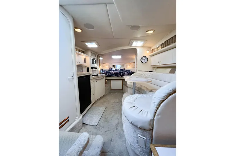 Slide: The Image of Interior of 2000 Sea Ray 340 Sundancer yacht with cozy seating and kitchenette. - 36