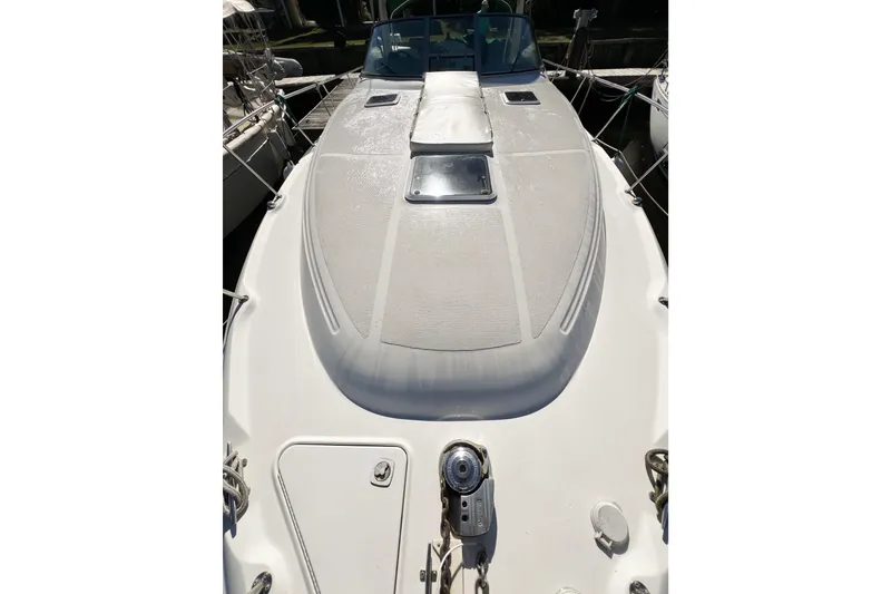 Slide: The Image of 2000 Sea Ray 340 Sundancer boat deck with sunpad and hatch, docked in marina. - 43