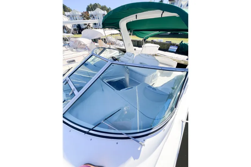 Slide: The Image of 2000 Sea Ray 340 Sundancer boat with green canopy docked at marina. - 45