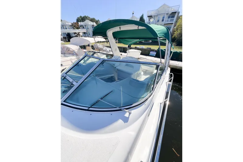Slide: The Image of 2000 Sea Ray 340 Sundancer boat with green canopy docked at marina. - 46