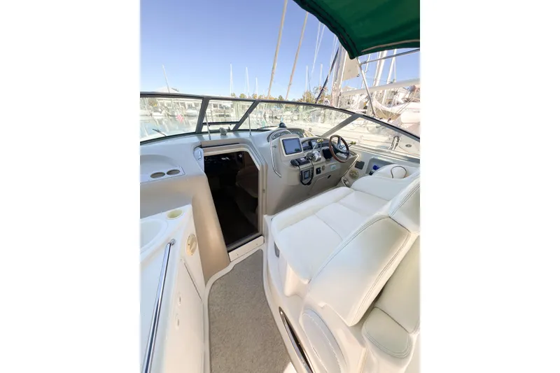 Slide: The Image of Interior view of 2000 Sea Ray 340 Sundancer boat cockpit with steering and seating. - 47
