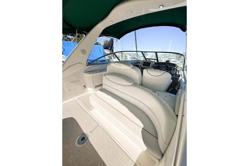 Slide: The Image of 2000 Sea Ray 340 Sundancer boat interior with white seating and green canopy. - 51