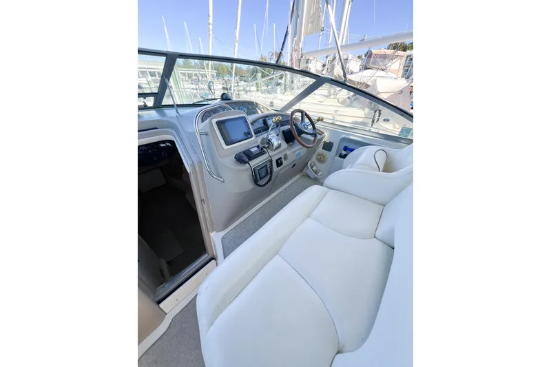Slide: The Image of Interior view of 2000 Sea Ray 340 Sundancer boat cockpit with steering wheel and controls. - 52