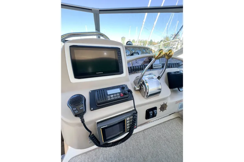 Slide: The Image of Control panel of 2000 Sea Ray 340 Sundancer with Garmin navigation system and communication equipment. - 53