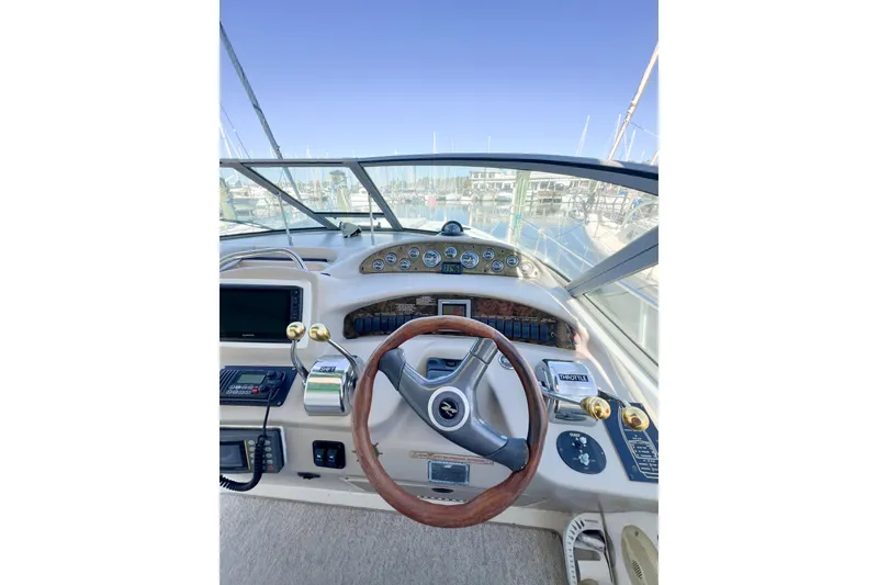 Slide: The Image of Cockpit view of 2000 Sea Ray 340 Sundancer with steering wheel and control panel. - 55