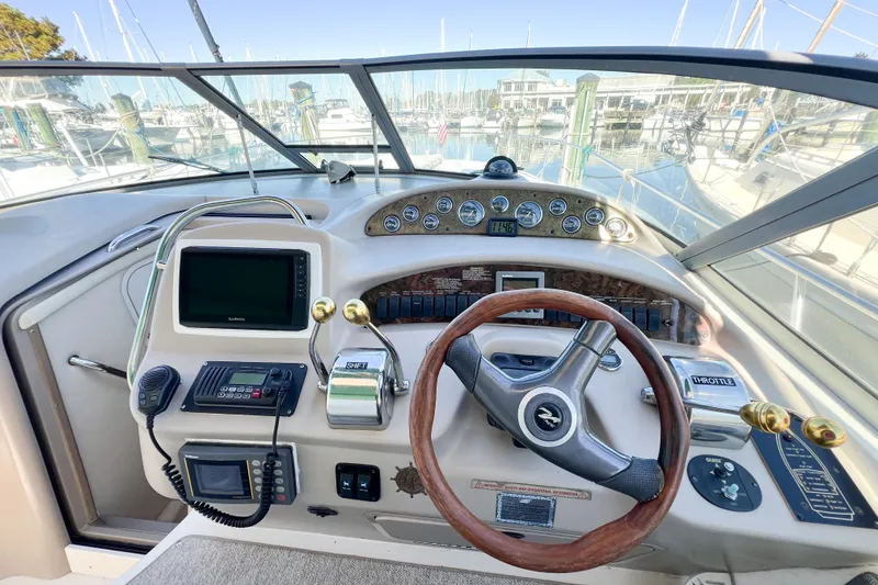 Slide: The Image of Cockpit of 2000 Sea Ray 340 Sundancer with steering wheel and navigation instruments. - 56