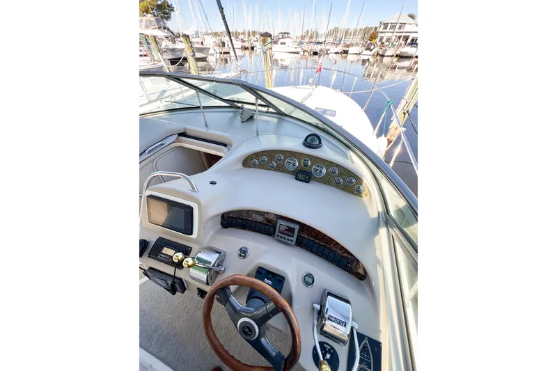 Slide: The Image of Helm of 2000 Sea Ray 340 Sundancer with gauges and controls, docked at marina. - 57