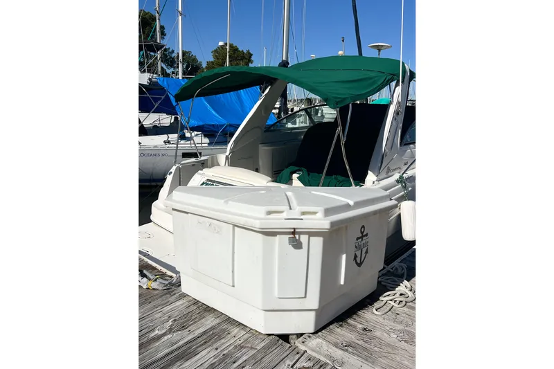 Slide: The Image of Sea Ray 340 Sundancer 2000 docked with green canopy and storage box. - 58