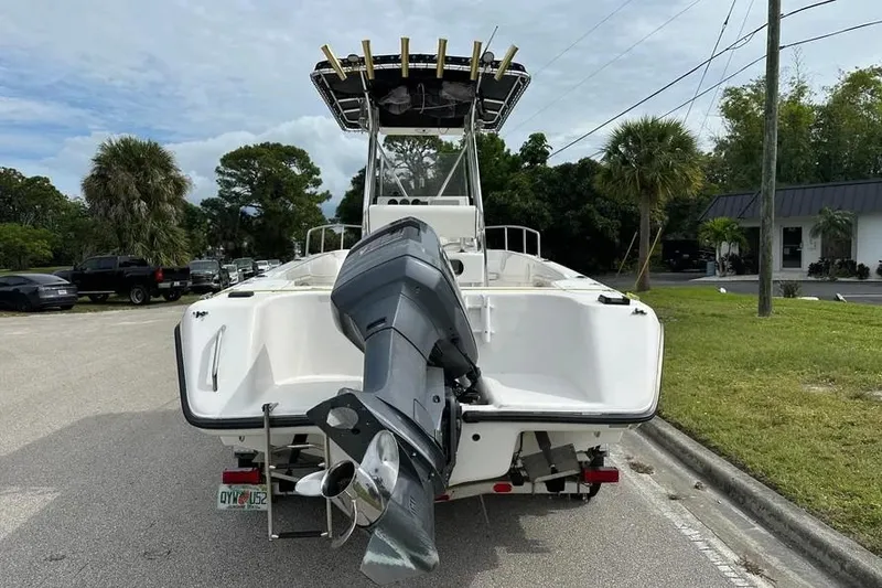 Slide: The Image of 2001 Century 2300 Center Console boat with outboard motor on a street. - 10