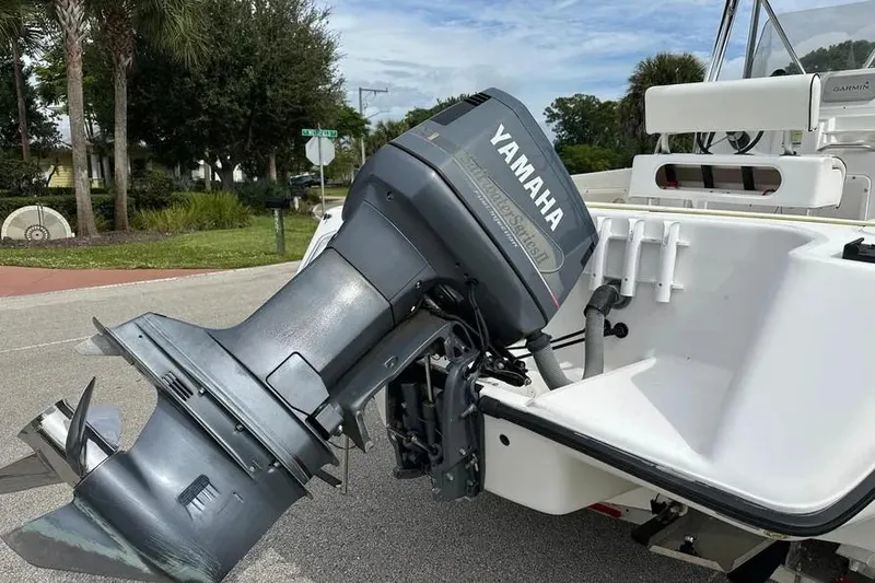 Slide: The Image of Century 2300 Center Console 2001 with Yamaha outboard motor, parked on a street. - 12